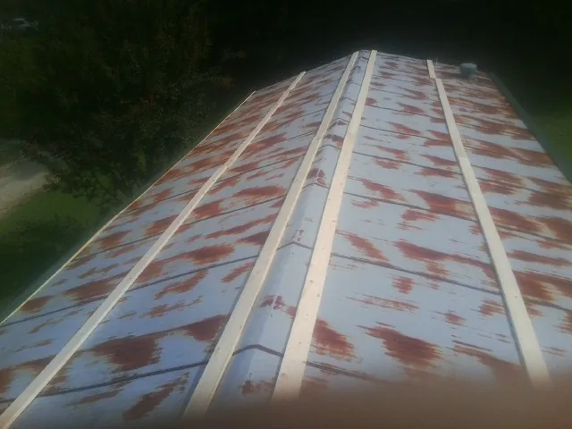 Rusted metal roof panels with new wood purlins before replacement — Storm Damage Roof Repair in Barryville by Roofing Brothers
