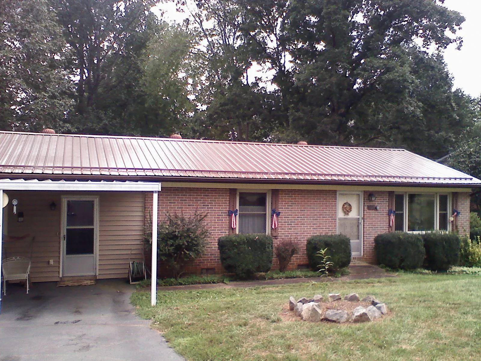 Bronze metal roof and carport on a brick ranch home — Roof Repair work by our crew in Barryville